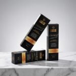 Três caixas de Colorizze Coloração Creme Permanente - Pague 2 nível 3 (combo 3 unidades) são mostradas em uma superfície de mármore branco, com duas na vertical e uma encostada na diagonal.